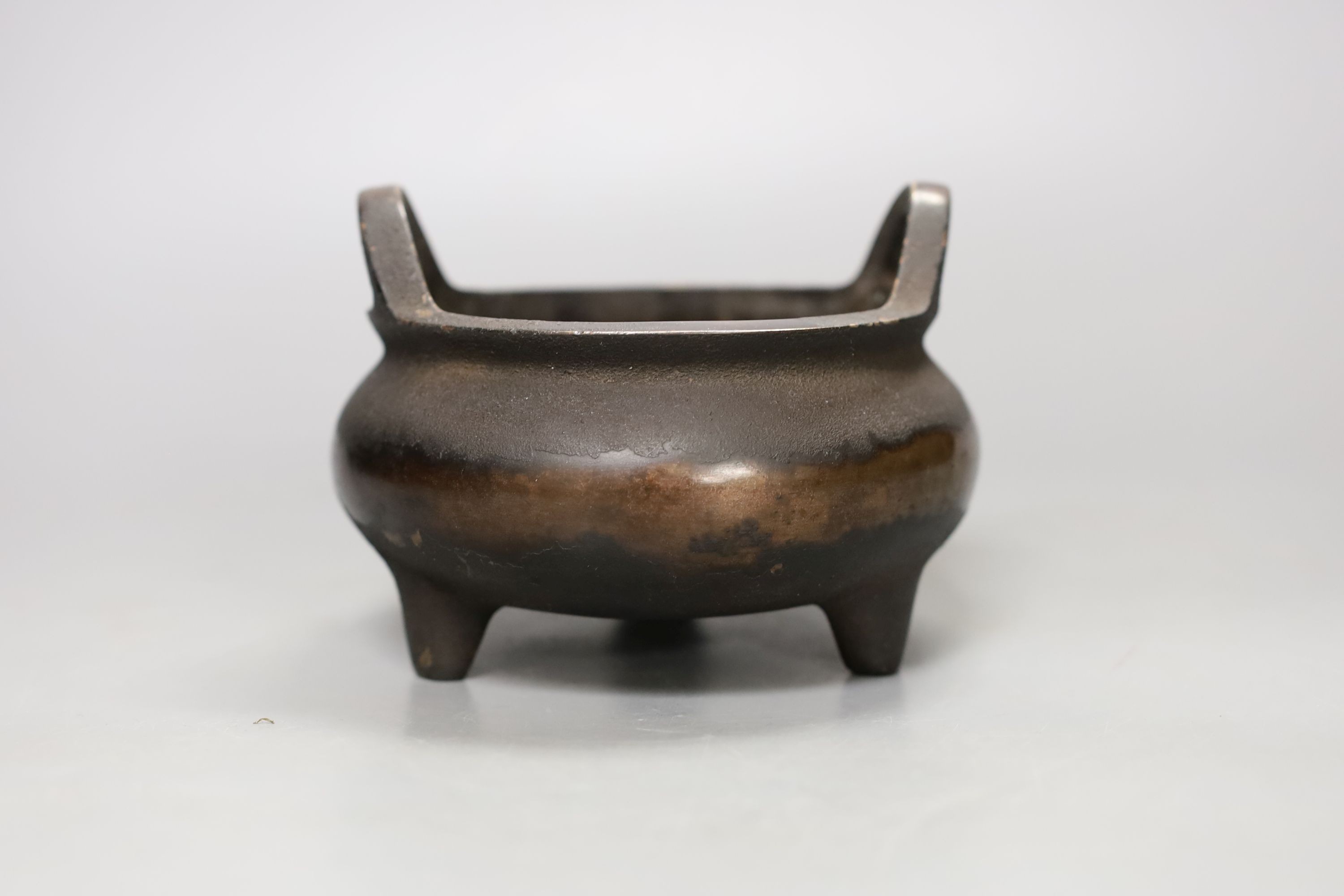 A Chinese bronze tripod censer, Xuande mark, 14 cm wide
